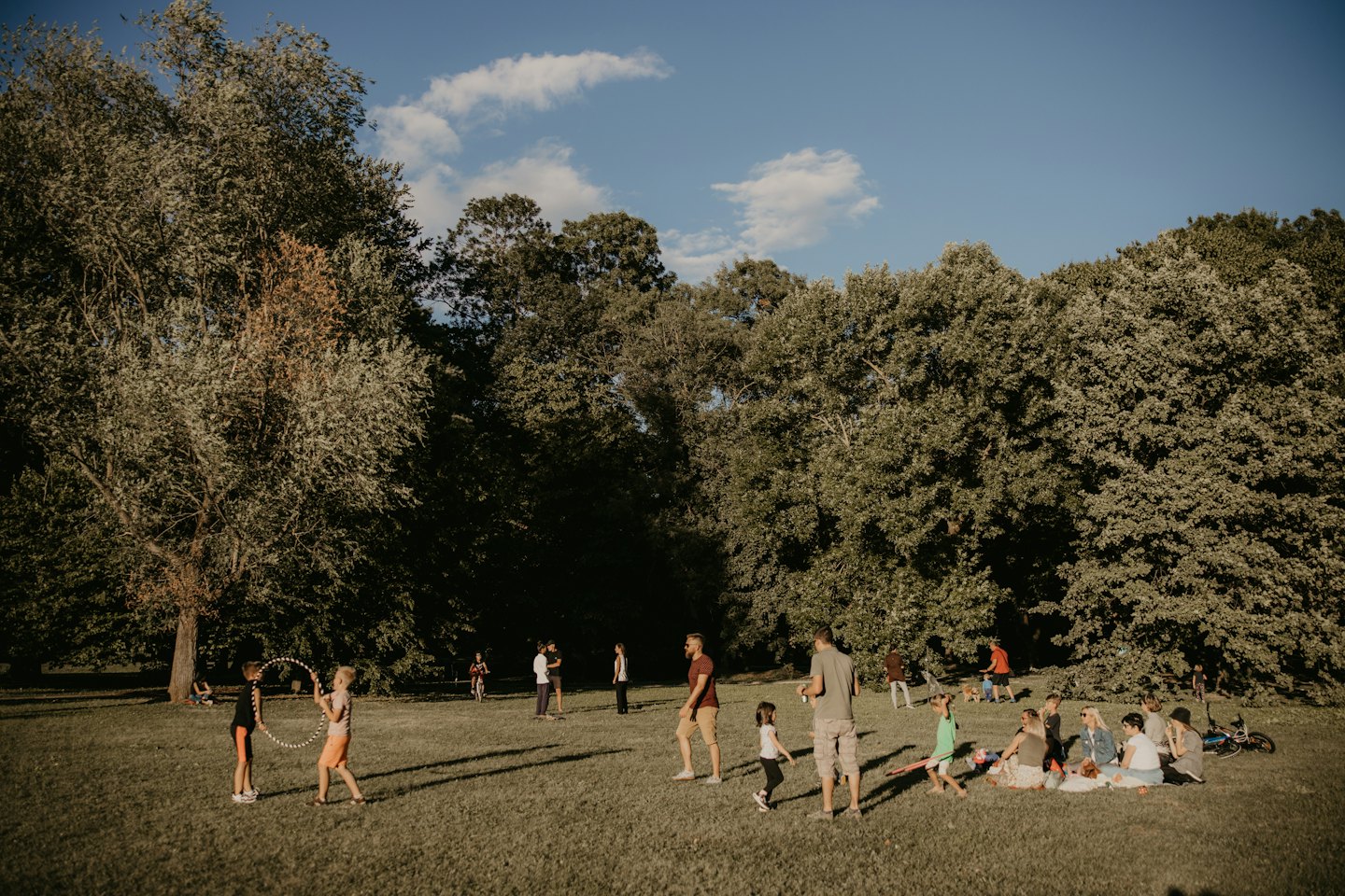 People enjoying outdoor activities in a sunny park.
